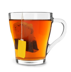 Glass cup of hot aromatic tea on white background