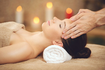 Obraz na płótnie Canvas Smiling Woman Getting Massage in Health Spa