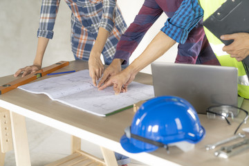 woman civil architect engineer discussion of building with building plan,engineering and architecture concept.Blue print is fake only for stock photo.