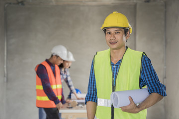 woman civil architect engineer discussion of building with building plan,engineering and architecture concept.Blue print is fake only for stock photo.