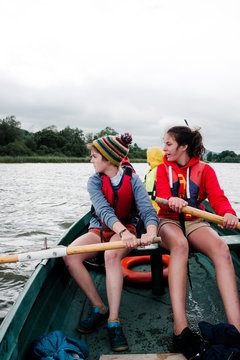 teens and kids on rowboat