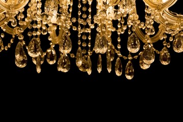 Gallant chandelier with black background and bottom copyspace. Luxury candelabra hanging on ceiling with lots of little gems - obrazy, fototapety, plakaty