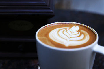 Cafe latte standing on the marble table.