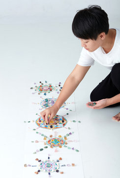Mandala pattern with crystal and Asian women. a creator