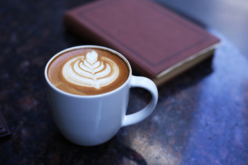 Cafe latte standing on the marble table.