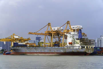Fototapeta premium Container Cargo freight ship with working crane bridge for export and import in the sea