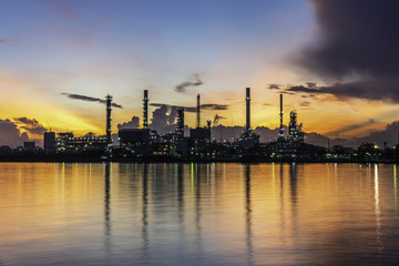 Silhouette oil refinery and Petrochemical plant at dusk at sunrise