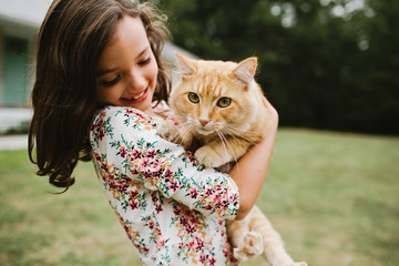 little girl holding cat