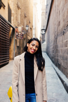 Portrait of a smiling stylish woman in the street.