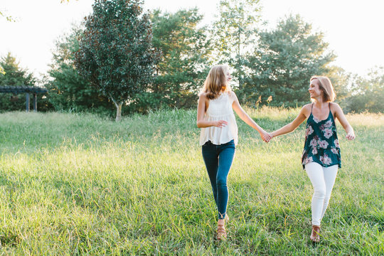 Two young girls walking in field