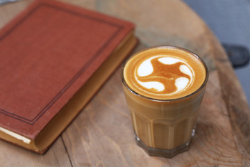 Cafe latte standing on the wood.