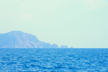 Fototapeta premium Pirate ship and foggy island against a cloudy sky on a sunrise. Seaside of Alanya, Turkey.