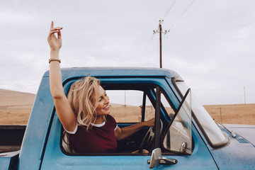 Beautiful woman enjoying driving a truck