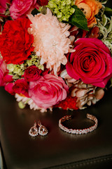 Obraz na płótnie Canvas Colorfully Beautiful Wedding Flowers Bouquet on the Beach with Jewelry