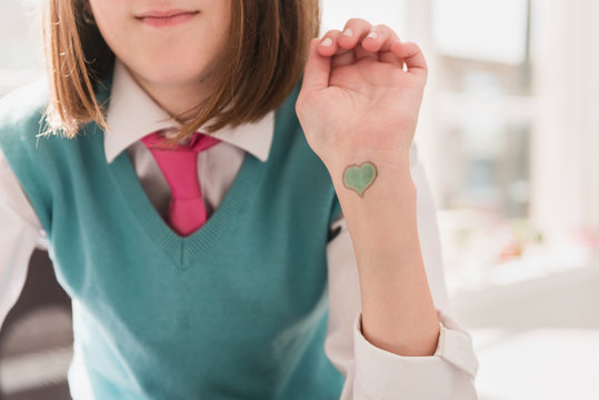 tween girl with loveheart drawn on her wrist