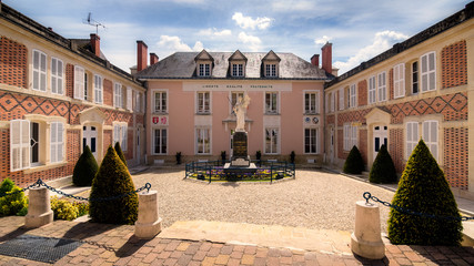 Beautiful rose facade of Hautvillers town hall near Reims, Marne, France