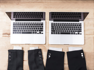 Two business suits of female and male with two laptops. Flat lay style. Business concept.