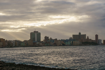 Fototapeta na wymiar sunrise on the beach with buildings on the shore