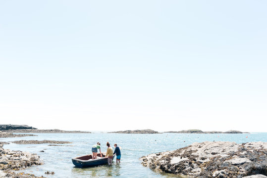 kids on rowboat at sea