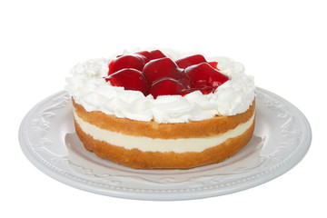 Light refreshing vanilla cake with cream filling, topped with whipped cream and glazed whole strawberries. Fresh summer fruit. Isolated on white background.