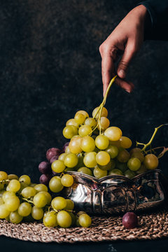 Hand holding fresh juicy grape