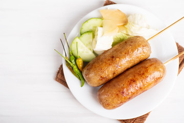 Thai sausage, fermented rice with pork sausage served with vegetables, top view