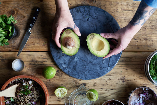Woman preparing avocado.