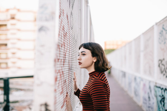 Woman standing near graffiti wall