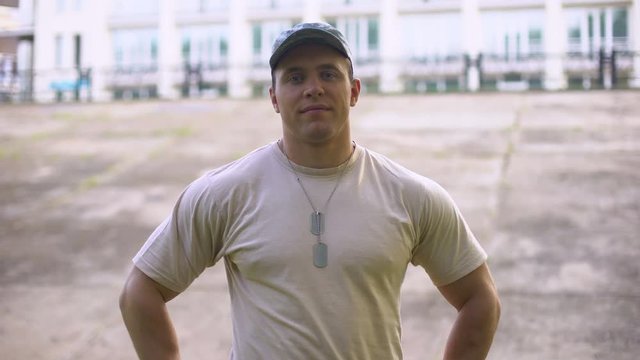 Handsome sergeant looking at camera, armed forces, military training center