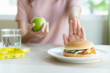 Woman on dieting for good health concept. Woman doing cross arms sign to refuse junk food or fast...