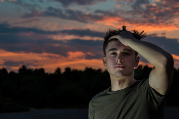 Young adult male outside at sunset