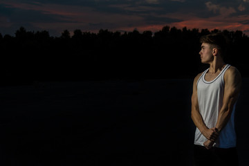 Fototapeta premium Young adult male outside at sunset