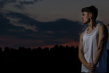 Young adult male outside at sunset