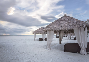 Long extension beaches and calmed sea at Marco Island Beach, Gulf of Mexico, Florida, USA. Palm Thatch at the beach. Stormy day in this amazing beach in southern Florida.