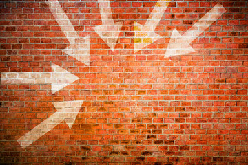 white arrows pointed at the center of vintage brick wall, decision making concept