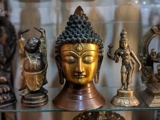 Metal sculpture of smiling Budha