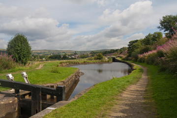 Fototapeta premium Pound and lock on the Huddersfield Narrow Canal, Uppermill, Oldham, Lancashire, England, United Kingdom