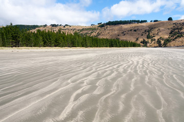 Sand patterns on the beach at Okains Bay, South Island, New Zealand
