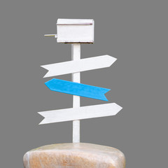 Wooden blank sign white and blue color with mailbox on stone isolated on gray background. Clipping path.