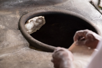 Chapati, Tandoori naan or roti - indian. Baked dough in earthen jar.