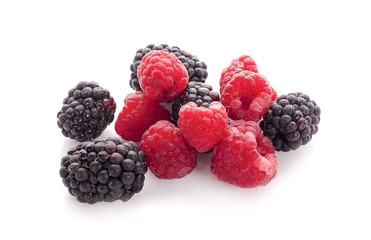 Blackberries and raspberries on white background