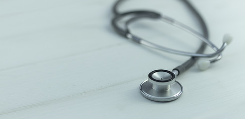 stethoscope on wooden table .left copy space