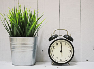 alarm clock on white wooden background