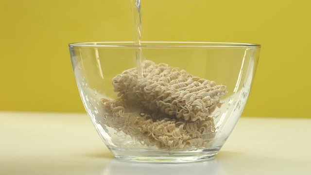 Cooking noodles with boiled water, fast food, unhealthy eating harmful to body