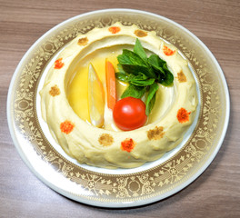 homos appetizer ( arab appetizer contains blended chickpeas mixed with spiced ,oil and tehinia )