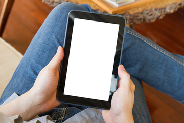 man using tablet computer in living room