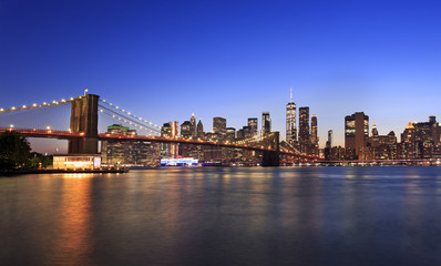 Brooklyn Bridge and New York City skyline at dusk