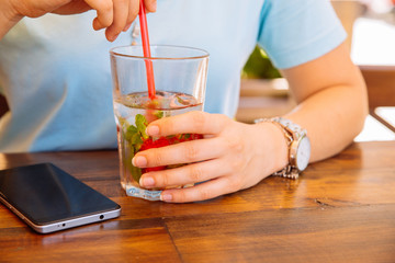 woman in cafe drinking cool drinks close up