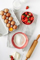 Bakery background Recipe strawberry pie Rustic style Ingredients cooking strawberry pie cake white table Flat lay top view Eggs flour milk sugar strawberry top view