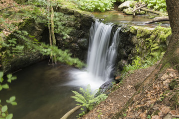 Fototapeta na wymiar Small waterfall in nature.
